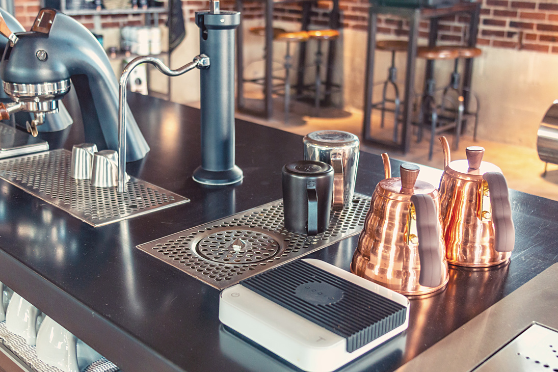 Professional coffee brewing station with espresso machine and pour-over kettles
